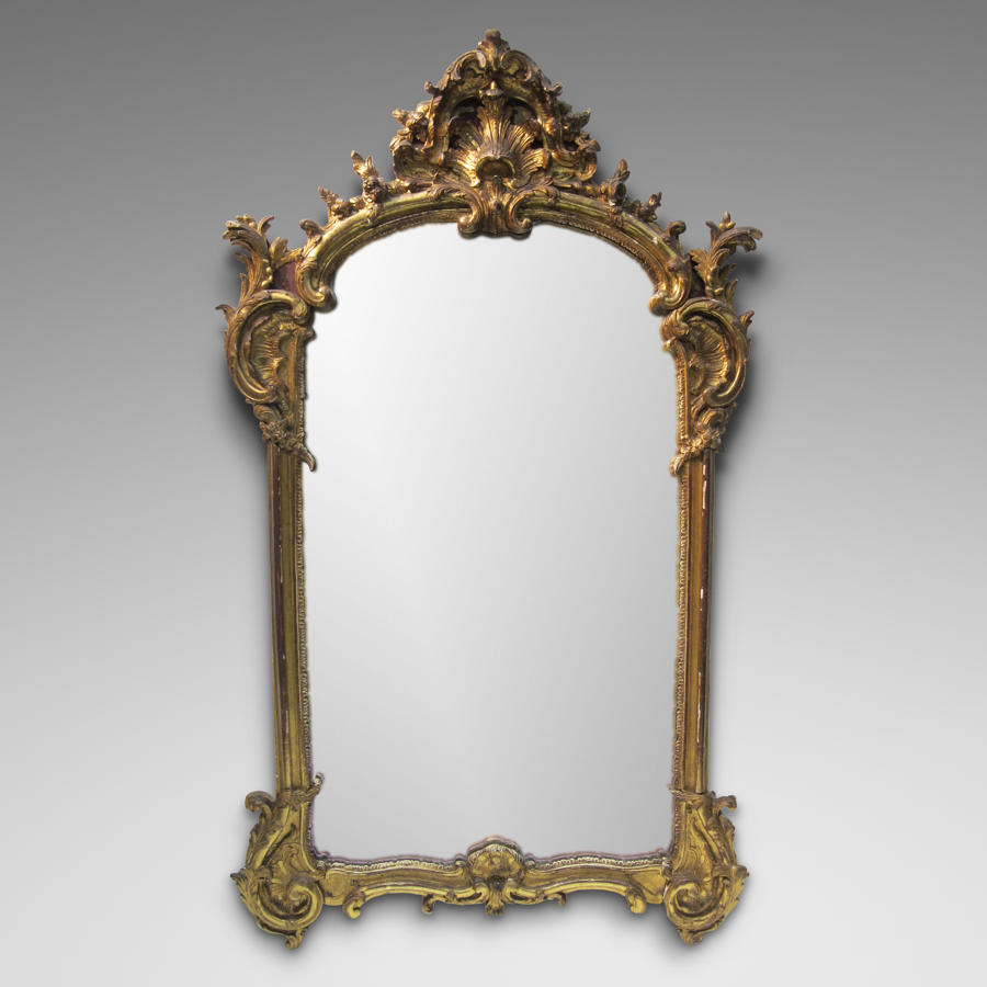 A LOUIS XV PERIOD CARVED GILTWOOD MIRROR