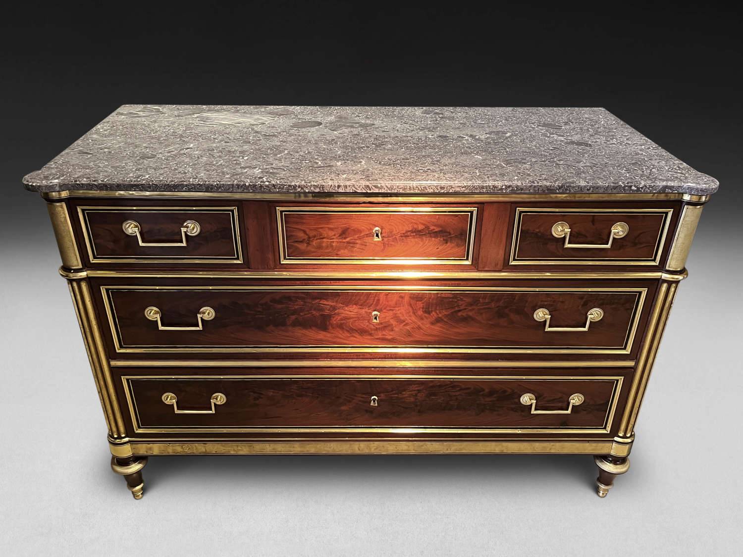 A LOUIS XVI PERIOD BRASS MOUNTED COMMODE