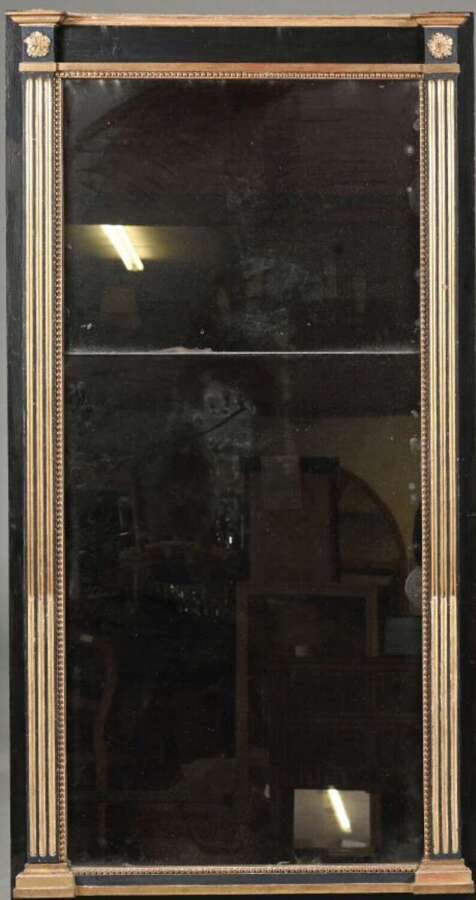 A LOUIS XVI PERIOD EBONISED & PARCEL GILT MIRROR
